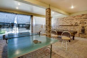 a ping pong table in a room with a pool table at Dularge Grand Villa - Steps to Marina and Fishing! in Theriot