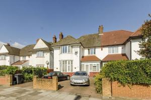 a house with two cars parked in front of it at Lynton Road in London