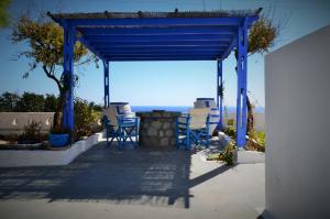 a blue gazebo with chairs and a table at Summer Residence in Provatas