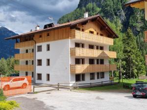 a building with wooden balconies on the side of it at Stella Alpina in Campitello di Fassa