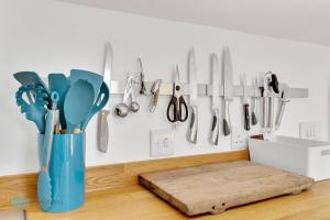 a kitchen counter with utensils hanging on a wall at 1 Bed - Bantham by Pureserviced in Plymouth