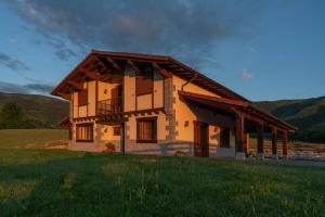 a house with a balcony in a field at LAIZARRONDO in Arantza