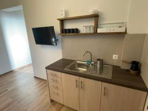 a kitchen with a sink and a counter top at Tzovolos Apartments in Kalavrita