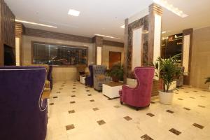 a waiting room with purple chairs and a lobby at Nozol Al Reef by Al Azmy in Riyadh