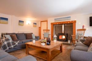 a living room with a couch and a table at The Post House - Seasgair Lodges in Kingussie