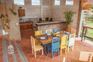 a wooden table and chairs on a patio at Raizes AXM I Casa Campestre I Armenia, Quindío, Colombia in Armenia
