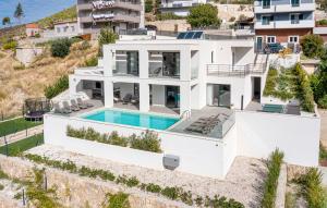 an aerial view of a white house with a swimming pool at Luxury Villa Mandy - Split in Žrnovnica