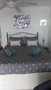 a bed with two pillows on it in a bedroom at Las Terricitas Old town Apartment in Puerto del Carmen