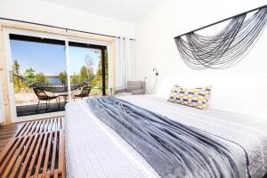 a bedroom with a bed and a large window at Stone Cove Waterfront Adults Only B&B in Tobermory