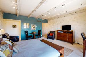 1 dormitorio con 1 cama, TV y mesa en Skyline View Studio, en Tucson