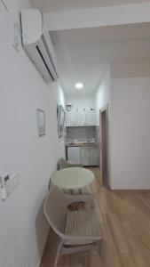 a white room with a table and a kitchen at Spasic Apartments Sutomore in Sutomore +47 photos