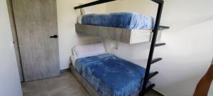 a room with two bunk beds and a door at Vista Hermosa Glamping y Cabañas in La Mesa