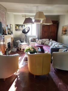 a living room with a couch and chairs at La PULCINELLA Maison de Famille in Pouzilhac