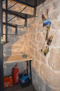 a room with a stone wall with a small table at VILLA MOST Tisno in Tisno
