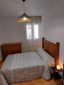 a bedroom with a bed and a window at El Nido de Candeleda in Candeleda
