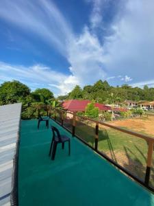 a view from the roof of a house with chairs at HOMESTAY JERAI GEOPARK in Guar Chempedak