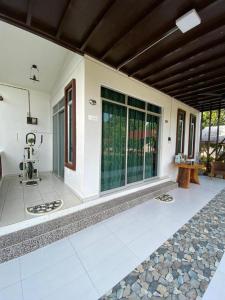 an outside view of a house with a patio at HOMESTAY JERAI GEOPARK in Guar Chempedak