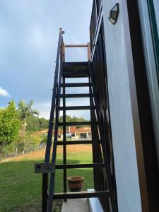 a ladder leading up to a door of a house at HOMESTAY JERAI GEOPARK in Guar Chempedak