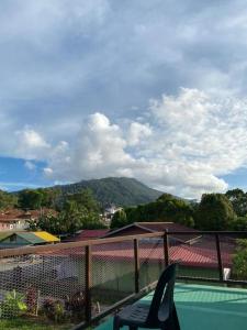 a balcony with a view of a tennis court at HOMESTAY JERAI GEOPARK in Guar Chempedak
