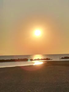 a sunset on the beach with the sun setting at Nice days in Pescara