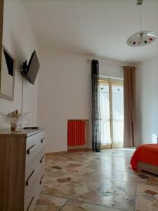 a bedroom with a red bed and a window at Nice days in Pescara