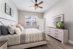 a bedroom with a bed and a dresser with a television at bsv_villa424 in Davenport