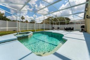 a swimming pool in a building with a glass ceiling at bsv_villa424 in Davenport