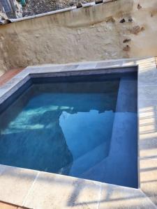 a large swimming pool with blue water at La PULCINELLA Maison de Famille in Pouzilhac