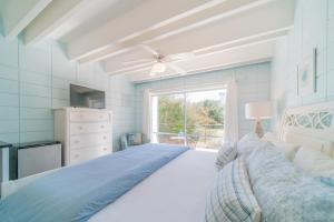 a large bedroom with a bed and a window at Cool Breeze Home in Inlet Beach