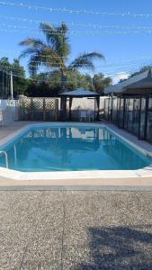 a blue swimming pool with a gazebo at I Girasoli in Bari