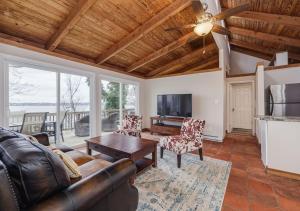 a living room with a couch and a table at 2 BR Newly Renovated Waterfront Home; 10 min from MGM & the Gaylord in Fort Washington