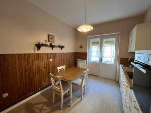 a kitchen with a table and chairs in a room at Apartman Maris in Crikvenica