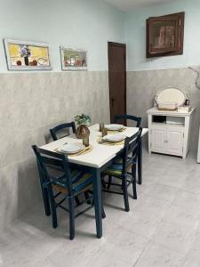 a dining room table with four chairs and a table at Casa 13 in Montargil +10 photos