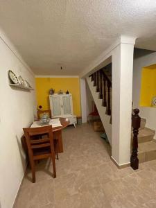 a room with a staircase and a table and a stair case at Casa 13 in Montargil