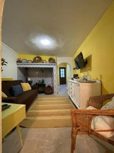 a living room with a couch and a fireplace at Casa 13 in Montargil