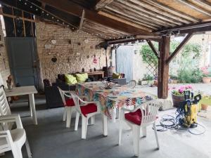 a dining room with a table and chairs at La Cour in Villefagnan