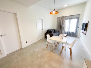 a living room with a table and a couch at Apartamentos La Canal in Soto de la Marina
