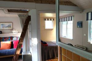 a room with a bunk bed and a window at Secluded cosy cabin near town centre in St Austell