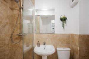 a bathroom with a shower and a toilet and a sink at CEFAS Apartments Manchester - Free Parking - City Centre in Manchester