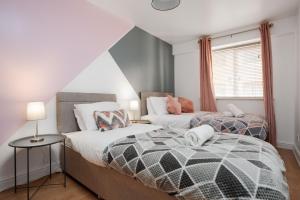 a bedroom with two beds and a window at CEFAS Apartments Manchester - Free Parking - City Centre in Manchester