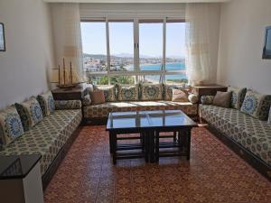 a living room with couches and a coffee table at Maison d'Hôtes Casa Azla in Azla