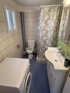 a bathroom with a toilet and a sink at Cozy Apartment in Hermoupolis in Ermoupoli