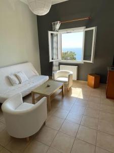 a living room with a bed and a table at Cozy Apartment in Hermoupolis in Ermoupoli