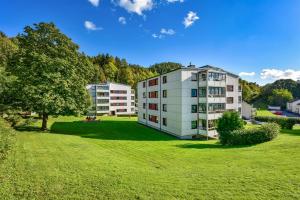 a building in a park with a green field at Apartement in Drammen close to the main city in Drammen