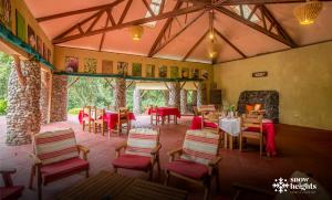 a restaurant with tables and chairs in a room at Snow Heights Lodges in Kasese +18 photos