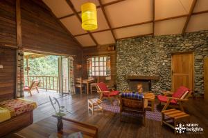 a living room with a stone wall at Snow Heights Lodges in Kasese