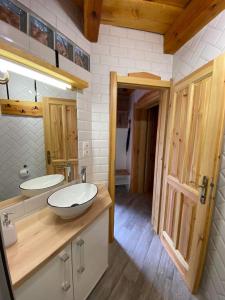 a bathroom with two sinks on a wooden counter at SZÍVES LAK 