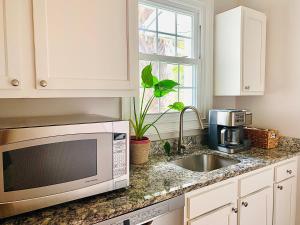 a kitchen with a microwave and a sink at The Drift in Charleston
