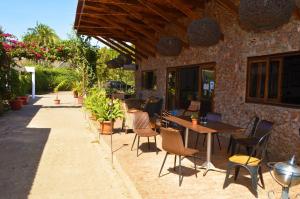 a patio with a table and chairs and a building at BOUGAINVILLA Boutique Hotel & Restaurant in Lubumbashi