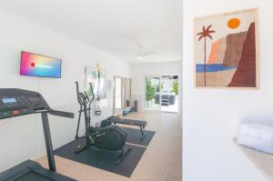 a living room with a treadmill and a gym at Villa Sound of the Sea by Portugal Collection in Aljezur